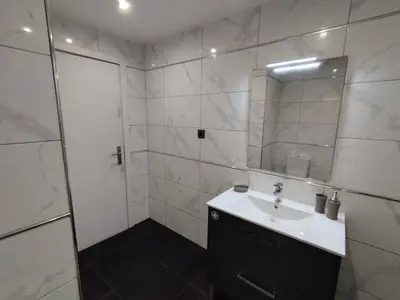 a white bathroom with a sink and a mirror at Ocean View Terrace by GALMI in Santa Cruz