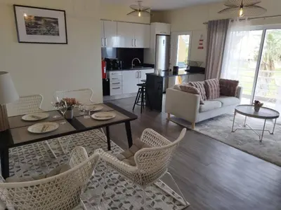 a kitchen and living room with a table and chairs at Ocean View Terrace by GALMI in Santa Cruz