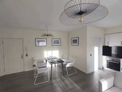 a living room with a table and white chairs at Ocean View Terrace by GALMI in Santa Cruz