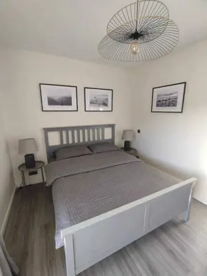 a bedroom with a large bed and a chandelier at Ocean View Terrace by GALMI in Santa Cruz