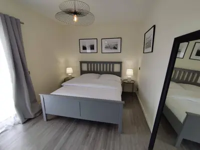 a bedroom with a large bed and a mirror at Ocean View Terrace by GALMI in Santa Cruz