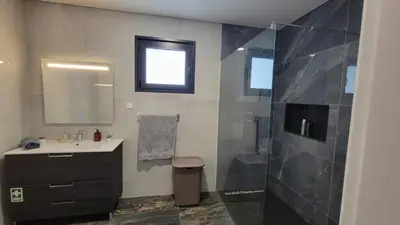a bathroom with a sink and a shower at Villa Bacana Oasis in Estreito da Calheta