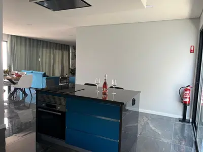 a kitchen with a blue and black counter top at Villa Bacana Oasis in Estreito da Calheta