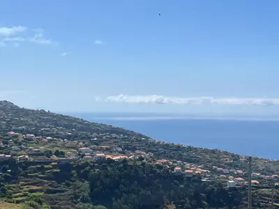 a town on a hill next to the water at Villa Bacana Oasis in Estreito da Calheta