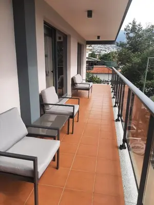 a bedroom with a large white bed with two pillows at Charm Residence Apartment - Free Park in Funchal