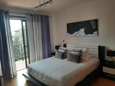 a balcony with couches and a view of a city at Charm Residence Apartment - Free Park in Funchal