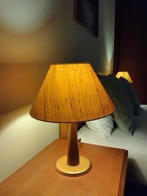 a brown lamp sitting on a table next to a bed at Ribeira Brava Studios - G in Ribeira Brava