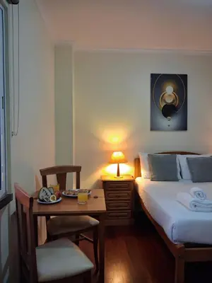 a bedroom with a bed and a table with a lamp at Ribeira Brava Studios - G in Ribeira Brava