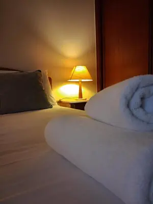 a bed in a room with a lamp on a table at Ribeira Brava Studios - G in Ribeira Brava