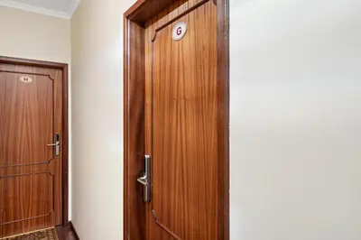 a wooden door with a clock on it in a room at Ribeira Brava Studios - G in Ribeira Brava