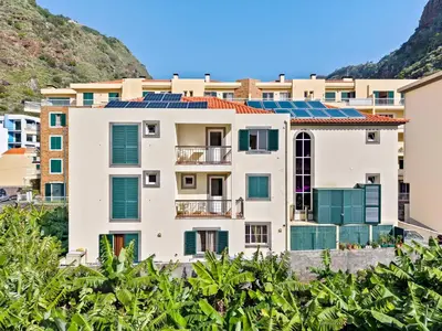 an apartment building with solar panels on it at Ribeira Brava Studios - G in Ribeira Brava