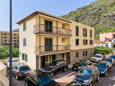 a group of cars parked in a parking lot in front of a building at Ribeira Brava Studios - G in Ribeira Brava