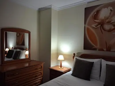 a bedroom with a bed with a dresser and a mirror at Ribeira Brava Studios - M in Ribeira Brava