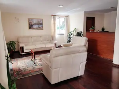 a living room with two white couches and a table at Ribeira Brava Studios - M in Ribeira Brava
