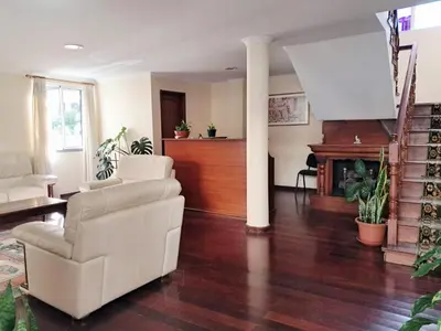 a living room with a white chair and a fireplace at Ribeira Brava Studios - M in Ribeira Brava