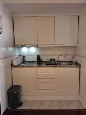 a small kitchen with white cabinets and a sink at Ribeira Brava Studios - M in Ribeira Brava