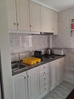 a kitchen with white cabinets and a sink at Ribeira Brava Studios - J in Ribeira Brava