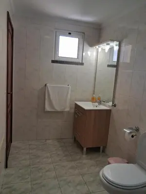 a bathroom with a toilet and a sink and a mirror at Ribeira Brava Studios - J in Ribeira Brava