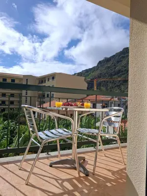 a table and two chairs on a balcony at Ribeira Brava Studios - J in Ribeira Brava