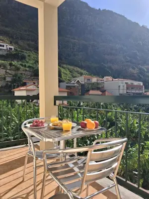 a table with fruit on it on a balcony at Ribeira Brava Studios - J in Ribeira Brava