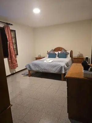 a bedroom with a bed with blue pillows at Charming Retreat Machico - 5 min Praia & Centro B in Machico