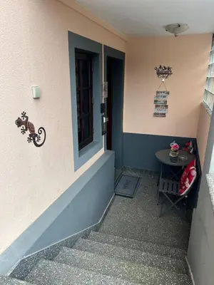 a small entrance to a building with a small table at Charming Retreat Machico - 5 min Praia & Centro B in Machico