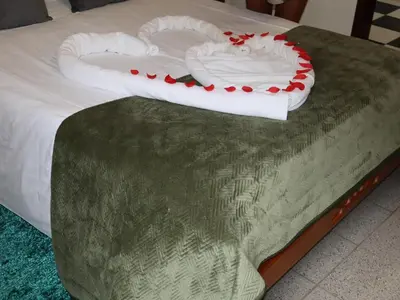 a bed with a heart shaped pillow on it at Charming Retreat Machico - 5 min Praia & Centro B in Machico