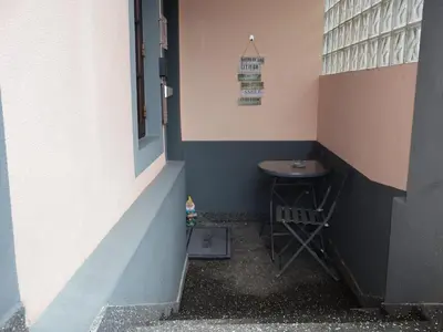 a small room with a stool in the corner of a building at Charming Retreat Machico - 5 min Praia & Centro B in Machico