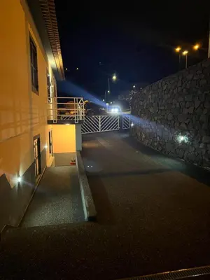 an empty street at night with a building at Charming Retreat Machico - 5 min Praia & Centro B in Machico