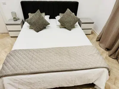 a bedroom with a large white bed with pillows at Stylish 3-bedroom flat in Funchal in Funchal