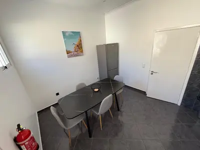 a dining room with a glass table and chairs at Stylish 3-bedroom flat in Funchal in Funchal