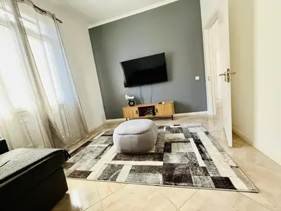 a living room with a television and a couch at Stylish 3-bedroom flat in Funchal in Funchal