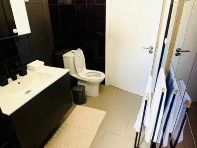 a bathroom with a white toilet and a sink at Stylish 3-bedroom flat in Funchal in Funchal
