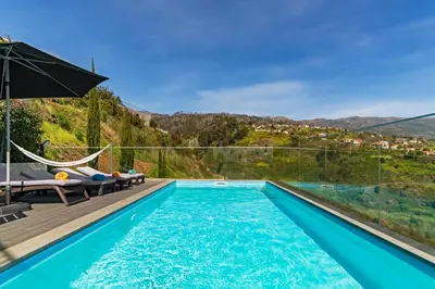 a swimming pool with a view of a mountain at Villa Clementina | Cliffs&Ocean | Heated Pool in Prazeres