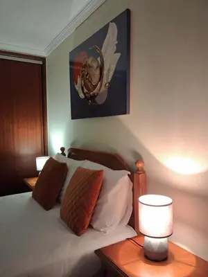 a bedroom with a bed and a lamp on a table at Ribeira Brava Studios - P in Ribeira Brava