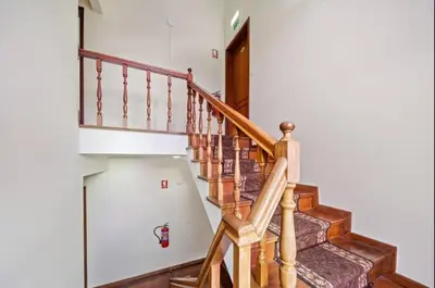 a staircase in a house with wooden railings at Ribeira Brava Studios - P in Ribeira Brava