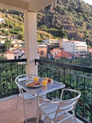 a table with a plate of food on a balcony at Ribeira Brava Studios - P in Ribeira Brava