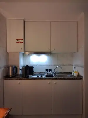 a kitchen with white cabinets and a sink at Ribeira Brava Studios - N in Ribeira Brava