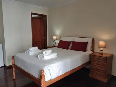 a bedroom with a bed with two towels on it at Ribeira Brava Studios - N in Ribeira Brava