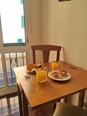 a table with two plates of food and two glasses of orange juice at Ribeira Brava Studios - N in Ribeira Brava