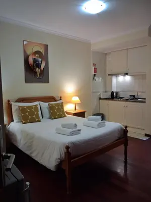 a bedroom with a bed with two towels on it at Ribeira Brava Studios - H in Ribeira Brava