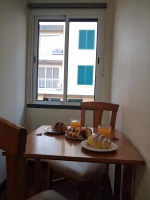 a table with two plates of food and two glasses of orange juice at Ribeira Brava Studios - H in Ribeira Brava