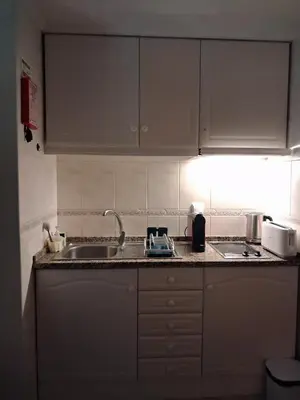 a kitchen with white cabinets and a sink at Ribeira Brava Studios - L in Ribeira Brava