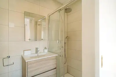 a bathroom with a sink and a glass shower at Family & Friends in Sagres