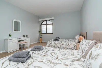 a bedroom with a bed and a desk and a window at Michaels View - Calheta in Estreito da Calheta