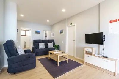a living room with a couch and a tv at Michaels View - Calheta in Estreito da Calheta