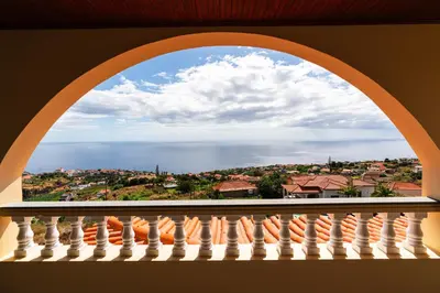 an arch window with a view of the ocean at Michaels View - Calheta in Estreito da Calheta