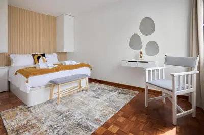 a bedroom with a bed and a desk and a chair at Jasmine Whisper by Elysian in Funchal