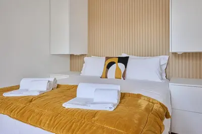 a large white bed with two towels on it at Jasmine Whisper by Elysian in Funchal