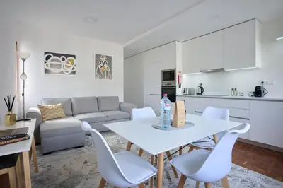a kitchen and living room with a white table and chairs at Jasmine Whisper by Elysian in Funchal